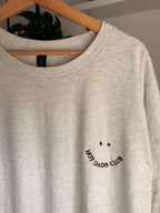 Ein T-Shirt in der Farbe Ash Heather mit einem Smiley bestickt "HOT DADS CLUB".